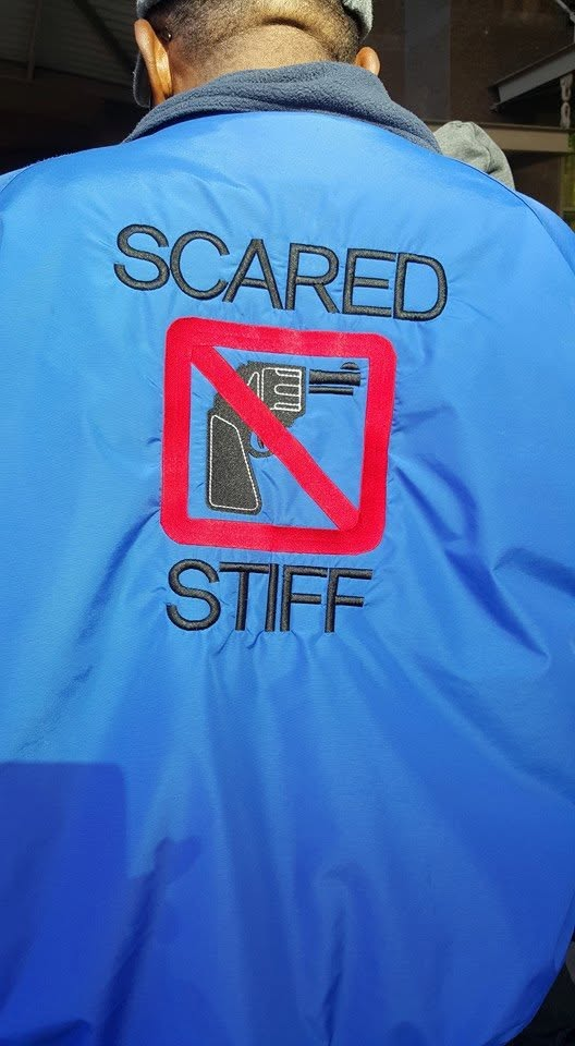 The back of a SCARED STIFF program jacket in blue, with the red no-guns logo and the words SCARED STIFF